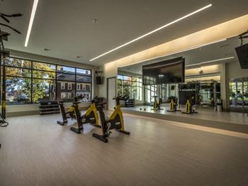 a gym with exercise equipment and a large window